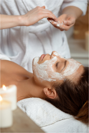 Young beautiful brunette girl in mask for face relaxing in spa salon. Eyes closed. Copy space.